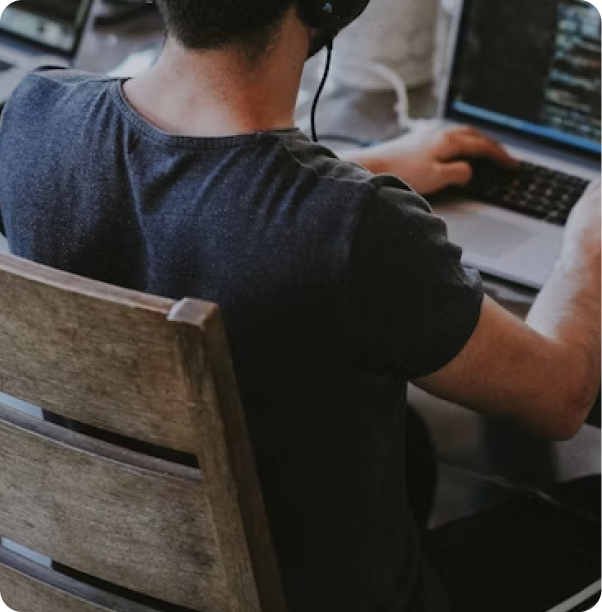 Male working on a laptop at a desk